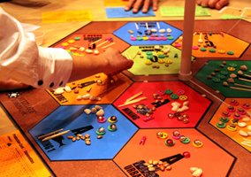 Image of a person moving a game piece